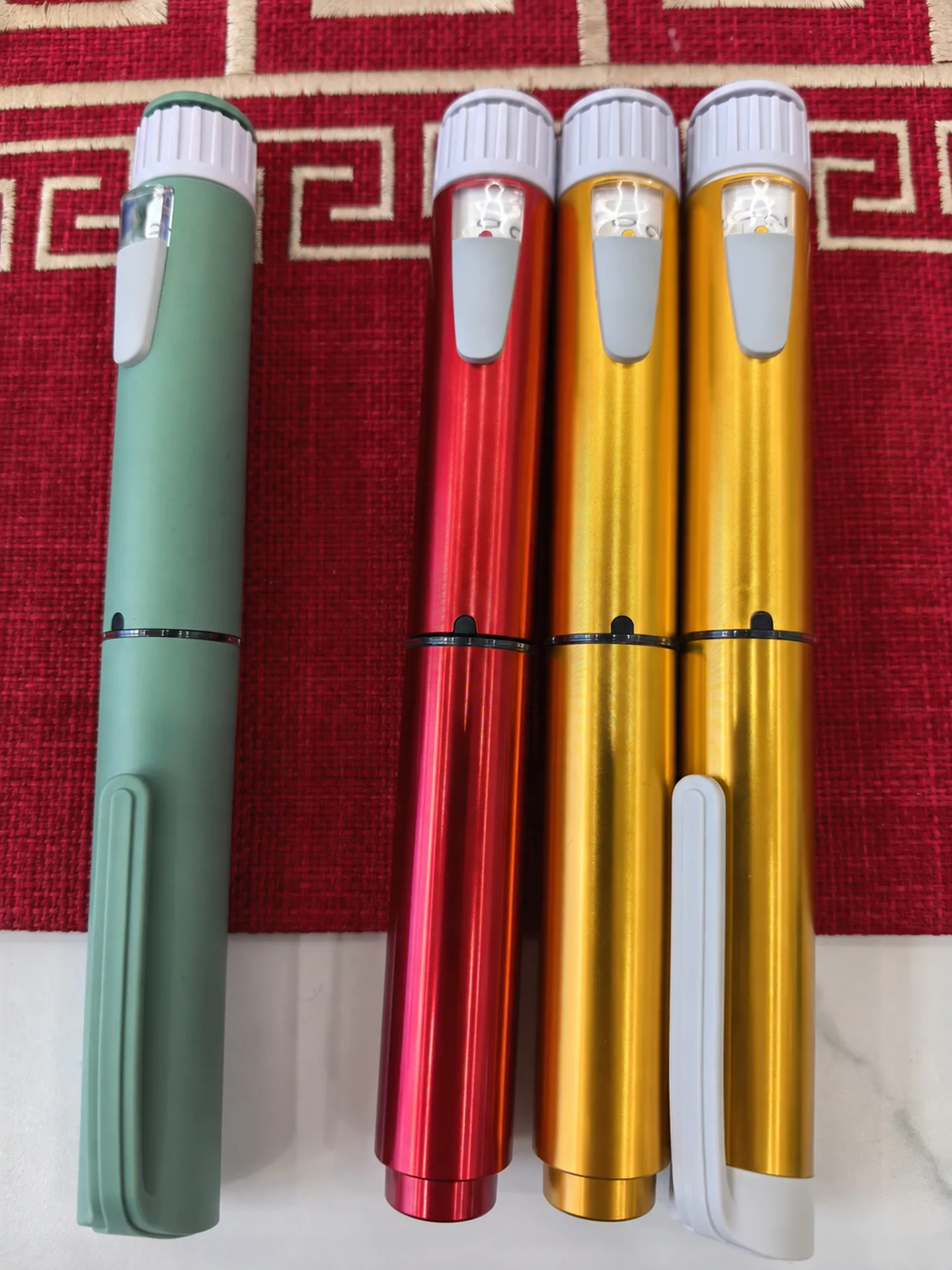 Supplier-provided green, red and gold injection pen samples